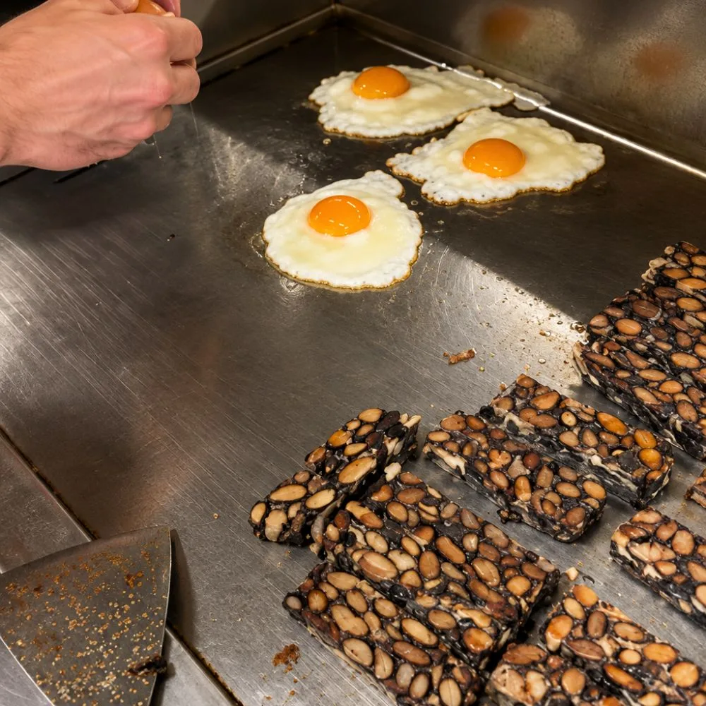 Käferbohnen Tempeh mit Ei auf großer Herdplatte
